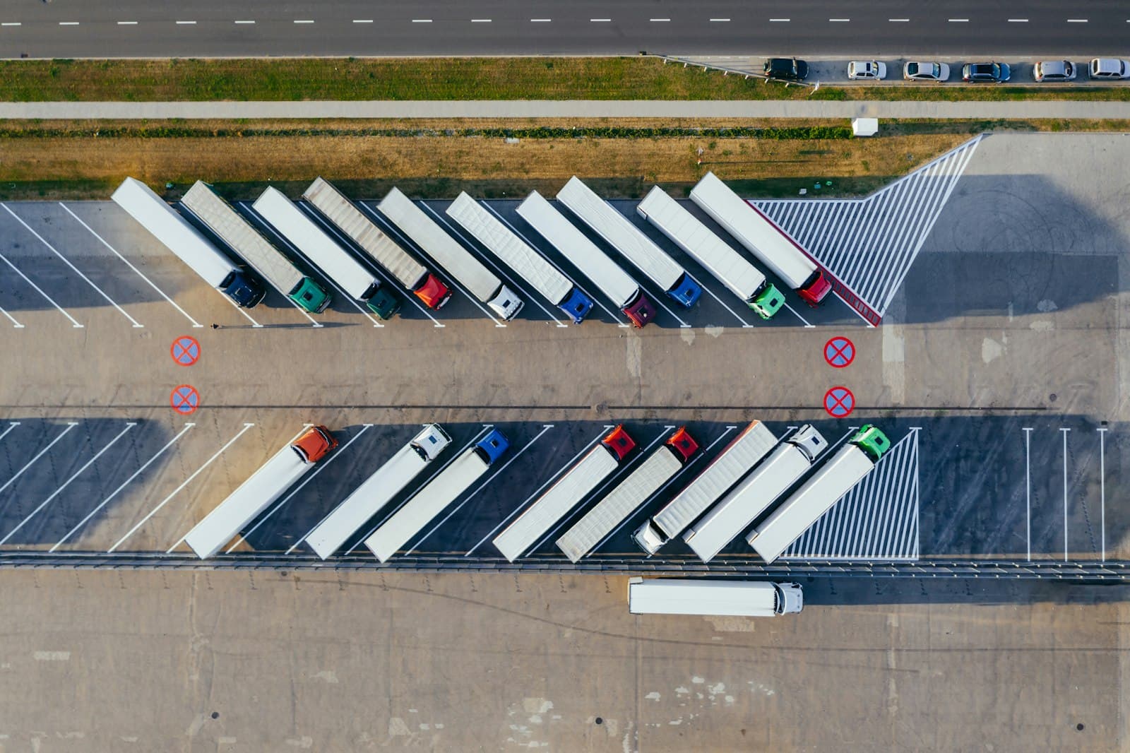 Photo: Marcin Jozwiak, Unsplash Aerial view of lorries parked in neat rows at a distribution depot