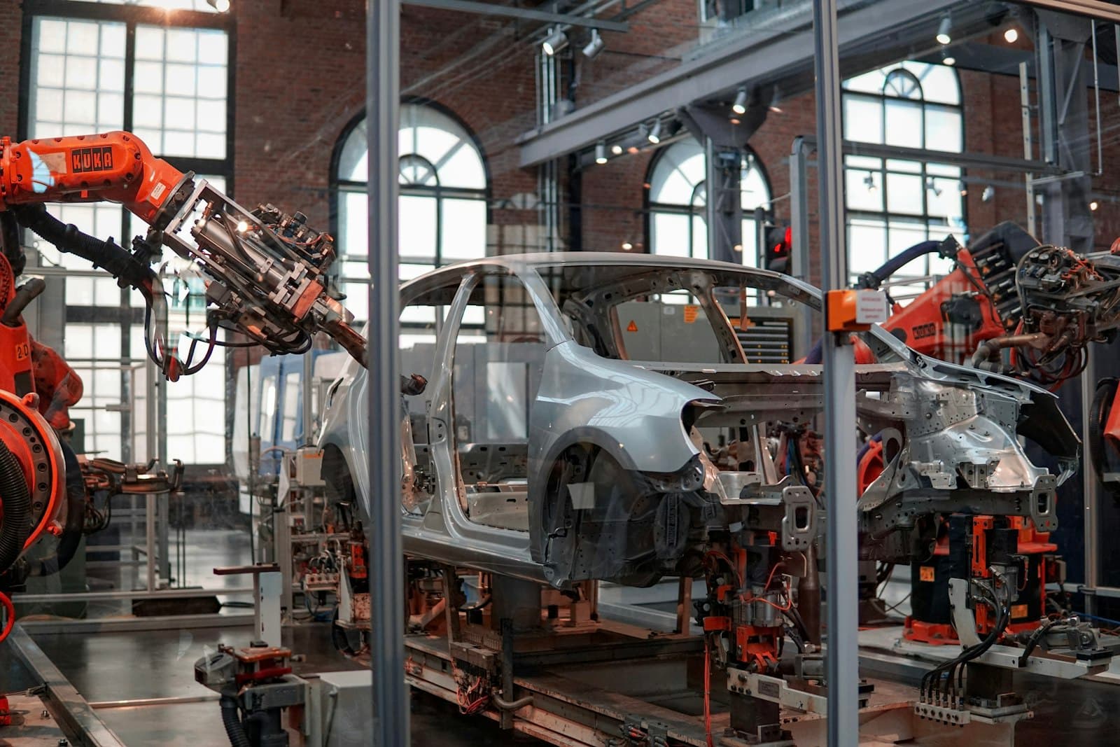 Photo: Lenny Kuhne, Unsplash Robotic arms on a car body assembly line