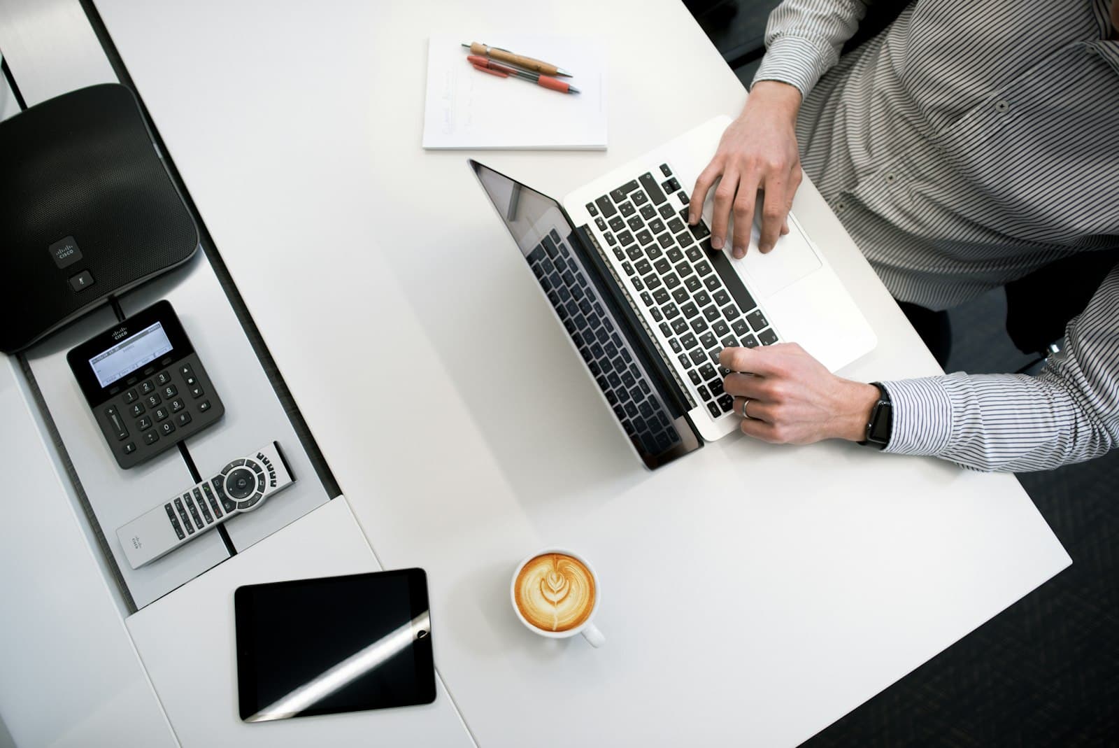 Photo: Bench Accounting, Unsplash Overhead view of a desk with a laptop, phone and coffee