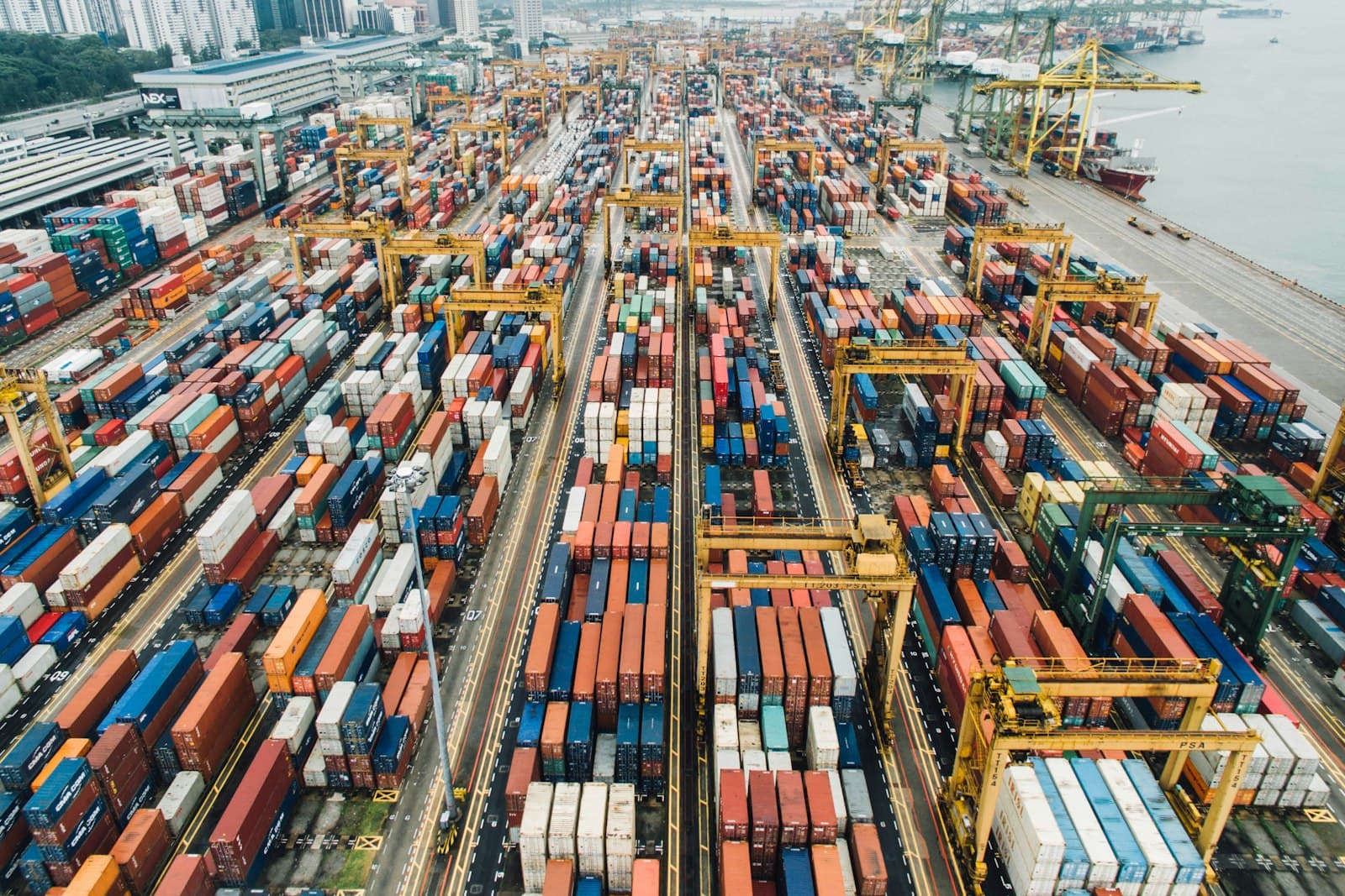 Photo: Unsplash Aerial view of a container terminal with stacked shipping containers