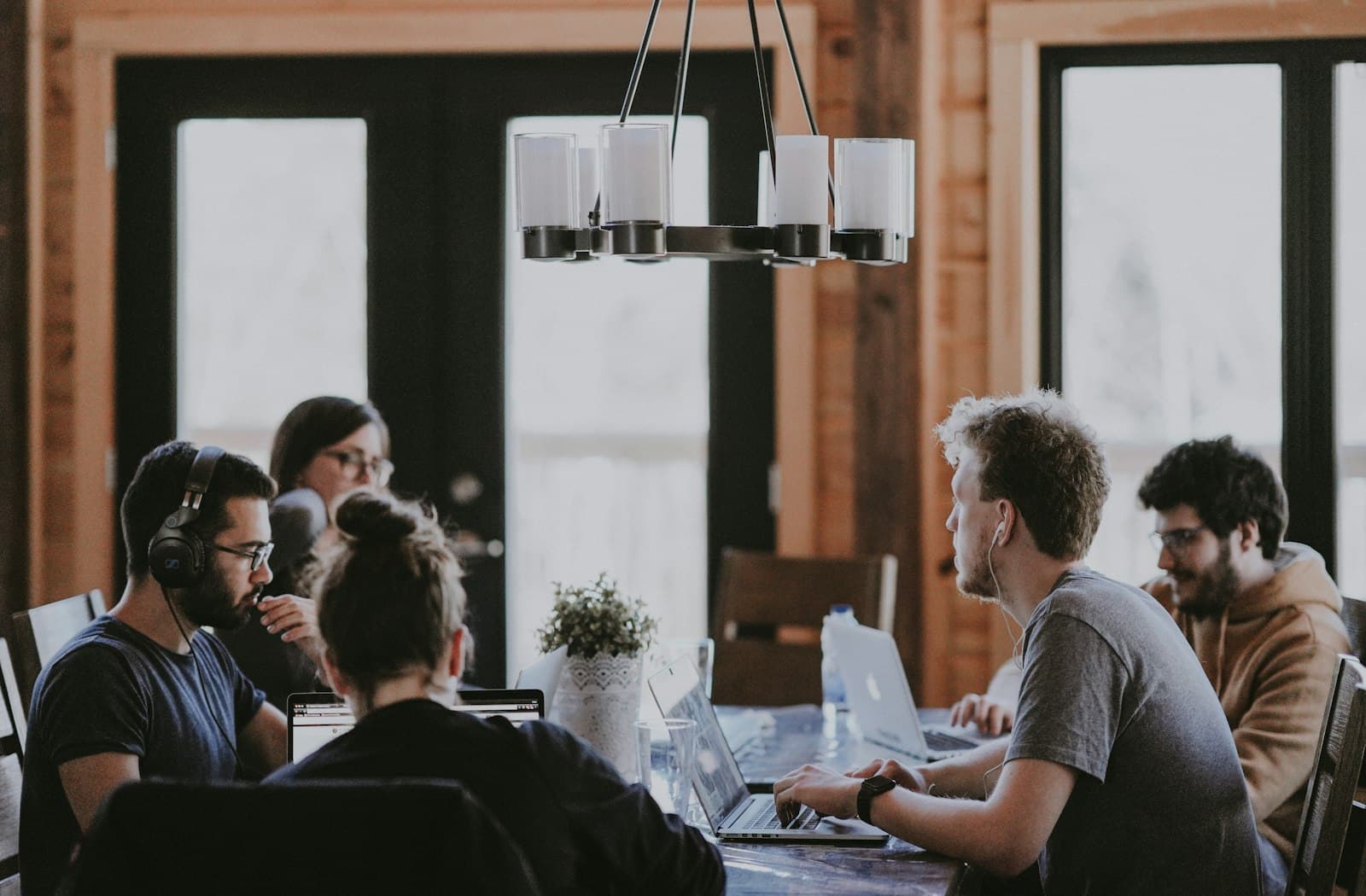 Photo: Annie Spratt, Unsplash Four people around a table in a meeting room