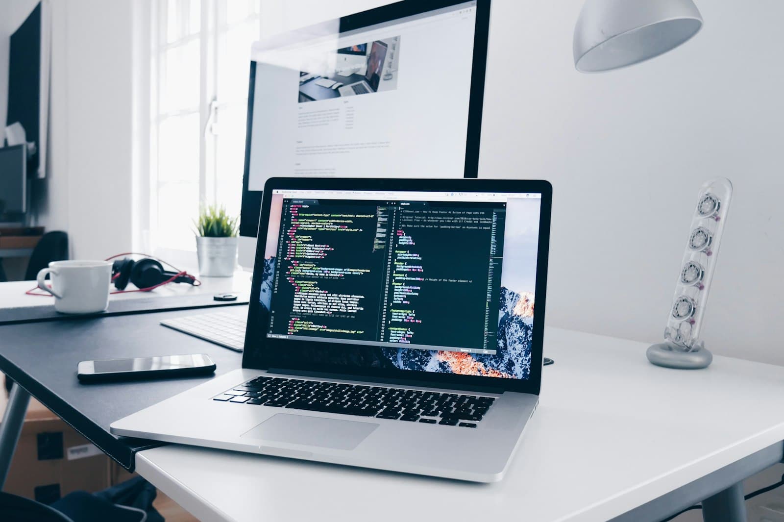 Photo: Christopher Gower, Unsplash A laptop on a desk showing source code in an editor