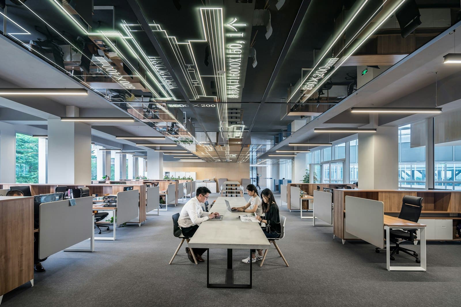 Photo: Austin Distel, Unsplash A wide open-plan office with people at work
